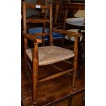 A child's rush seated ladder back armchair, 68cm high