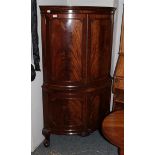 A George III style mahogany veneered corner drinks cabinet