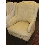 A yellow floral upholstered Victorian tub chair