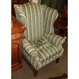 A Georgian style wing backed armchair with striped upholstery