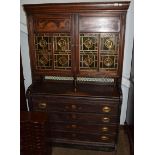 An Aesthetic glazed cabinet containing four drawers and a tiled back, the glazed door panels with