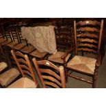 A set of nine rush seated ladder back chairs, including two carvers (9)