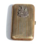 A Brass Cigarette Case, with engine turned decoration and surmounted by a badge engraved Gordon