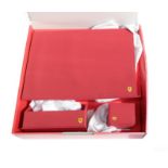 Ferrari Interest: An Official Red Leather Three Piece Desk Set, comprising a fold-out writing