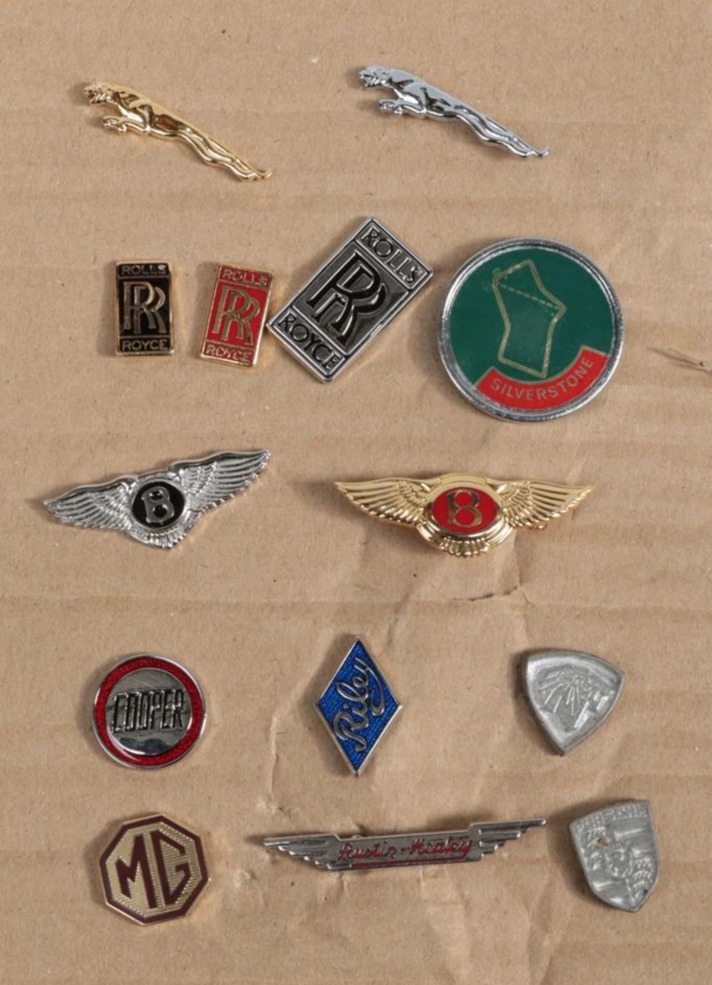 A Good Collection of Fourteen Motoring Lapel Badges, to include Jaguar, Rolls-Royce, Bentley,