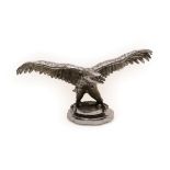 A 1930's Nickel on Brass Car Mascot as an Eagle, with wings outstretched standing on a circular