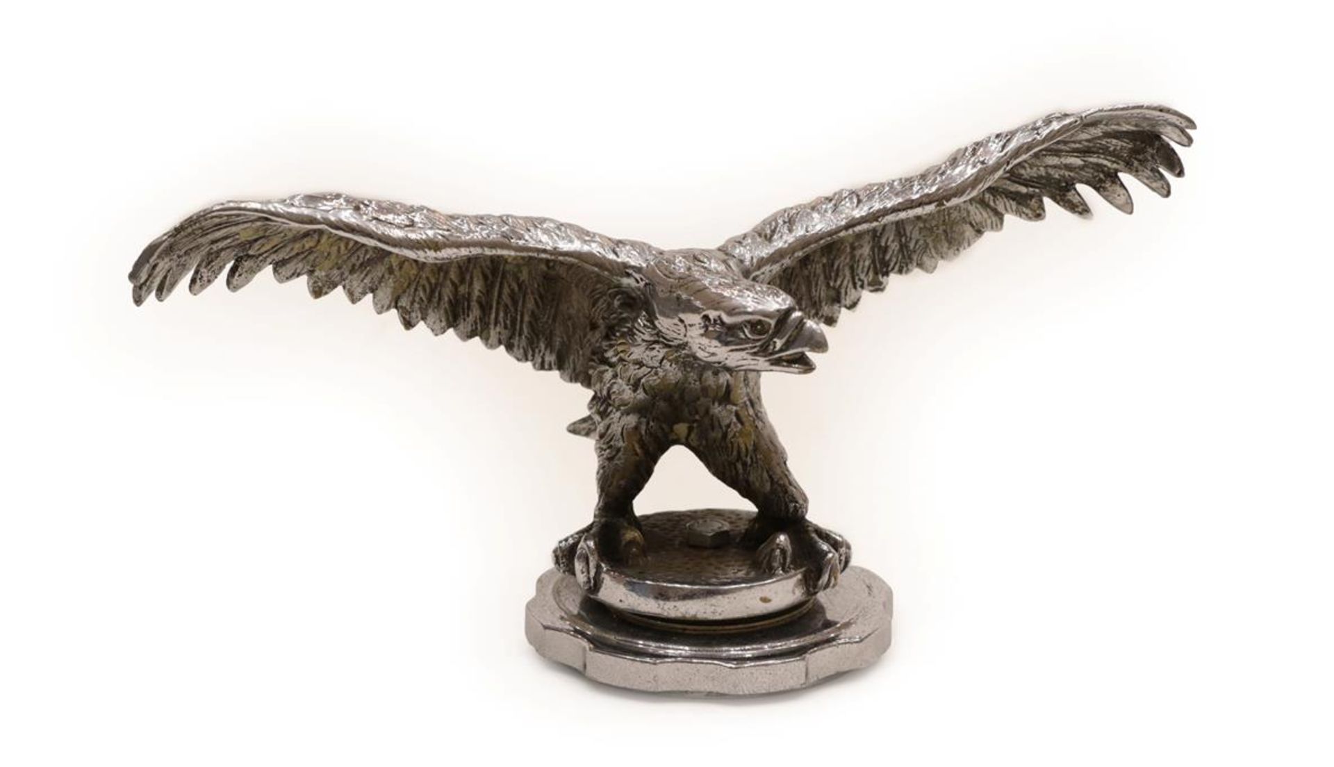A 1930's Nickel on Brass Car Mascot as an Eagle, with wings outstretched standing on a circular