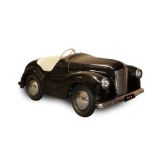An Austin J40 Black Painted Pedal Car, with cream three-spoke steering wheel and instrument panel,