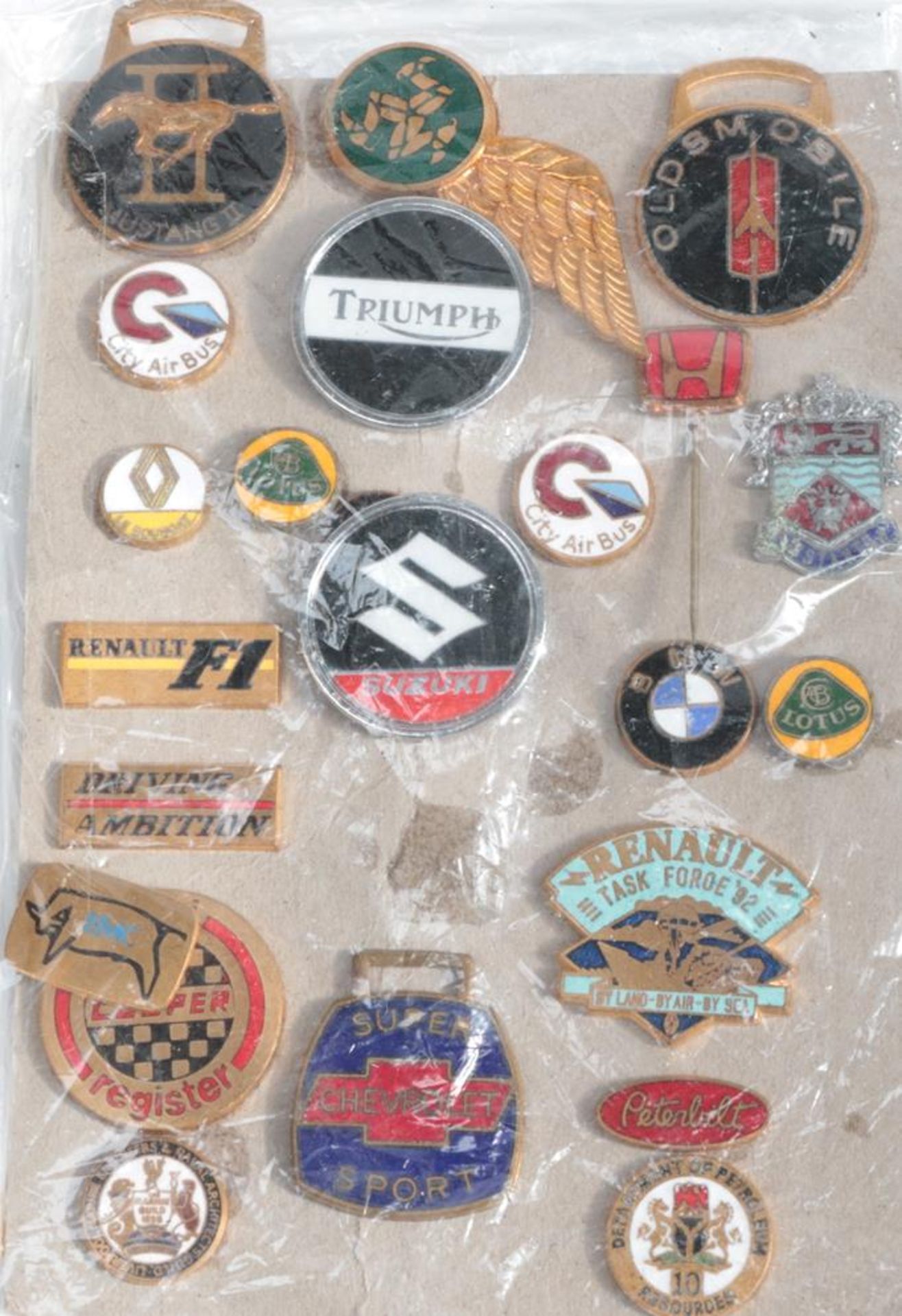 A Collection of Twenty-Three Vehicle Lapel Badges and Pins, to include Renault, Lotus, BMW, Triumph,