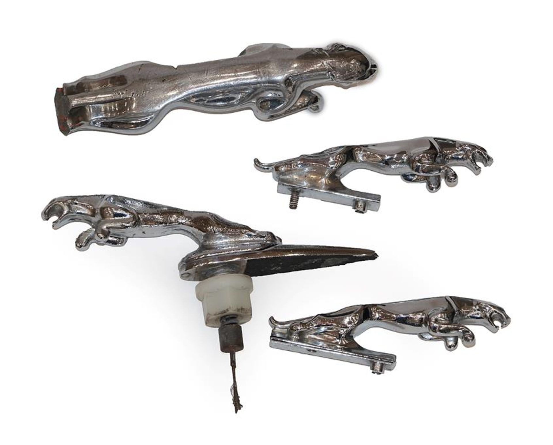 Four Vintage Jaguar Chrome Car Mascots, comprising a large example, 18cm wide (damaged), a pair of