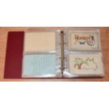 A small red album containing a collection of Embroidered Silk Postcards from the First World War