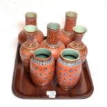 Mettlach comprising two pairs of vases and three other vases, all with iron red ground and impressed