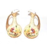 A pair of Vienna porcelain floral painted ewers, 25cm high . Each with wear to gilding and some