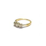 A diamond three stone ring, stamped '18CT', finger size M. Gross weight 2.4 grams.