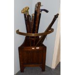 A linen-fold carved corner stick-stand, together with nine various walking sticks and other items