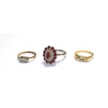 A diamond three stone ring, stamped '?CT' and 'PLAT', finger size K1/2; a five stone ring,