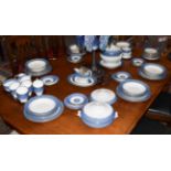 A Wedgewood part dinner and tea service with decorative blue and gilt borders comprising soup tureen