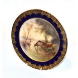 A Royal Worcester hand-painted plate, by John Stinton, decorated with cattle watering and with a