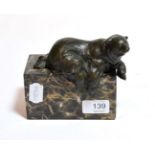 A 20th century bronze bear with foundry mark, modelled on a marble plinth base, 13cm high .