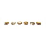 Three 9 carat gold gem set rings, various designs and sizes; two rings, stamped '9CT'; and a 15