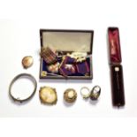 A 9 carat gold stick pin; a silver bangle; two cameo brooches; costume jewellery including a