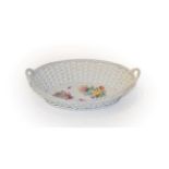 A 20th century Meissen porcelain basket, with twin handles and painted with floral sprays, 25cm