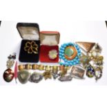 A quantity of costume jewellery including marcasite brooches, other brooches, earrings, beaded