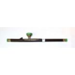 A Chinese green hardstone and white metal mounted hardwood opium pipe, 48cm long, the metal work