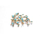 An abstract brooch, set throughout with blue stones, unmarked, length 6.3cm . Gross weight 19.1