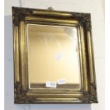 A Rococco style gilt brass mirror; together with a gilt gesso mirror and a pair of tarnished metal