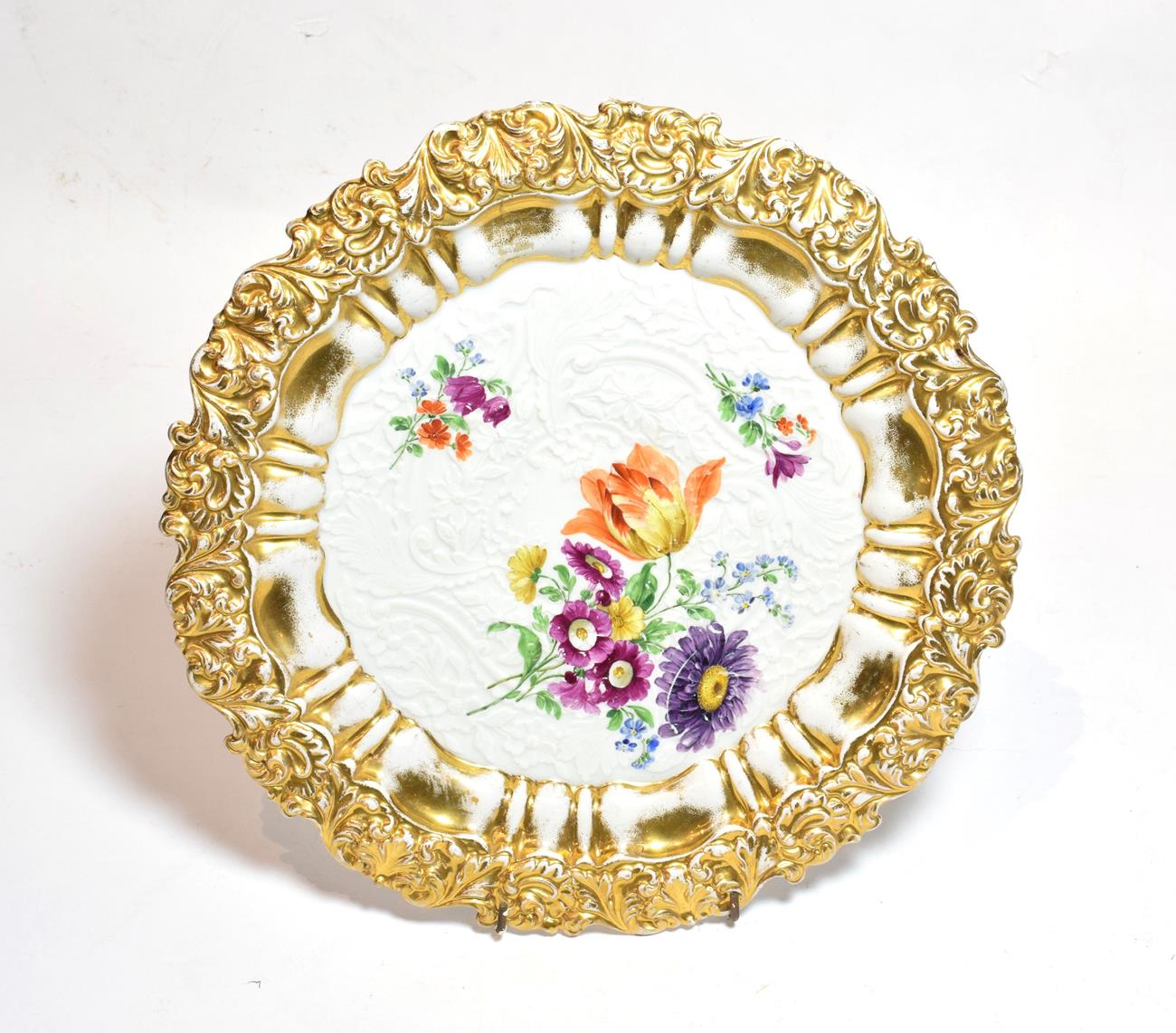 A 20th century Meissen floral painted plate, moulded in relief with gilt border, 31cm diameter .