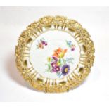 A 20th century Meissen floral painted plate, moulded in relief with gilt border, 31cm diameter .