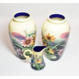 A pair of Old Tupton ware floral decorated vases, 29cm high; and a similar jug (3) . All pieces with