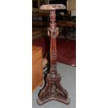 An ornately carved torchere