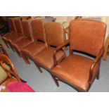 A set of six studded leather dining chairs, including one carver