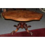 A 19th century quarter veneered walnut loo table, the shaped top above a pierced scroll carved and