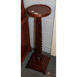 A Victorian mahogany torchere with boldly turned standard