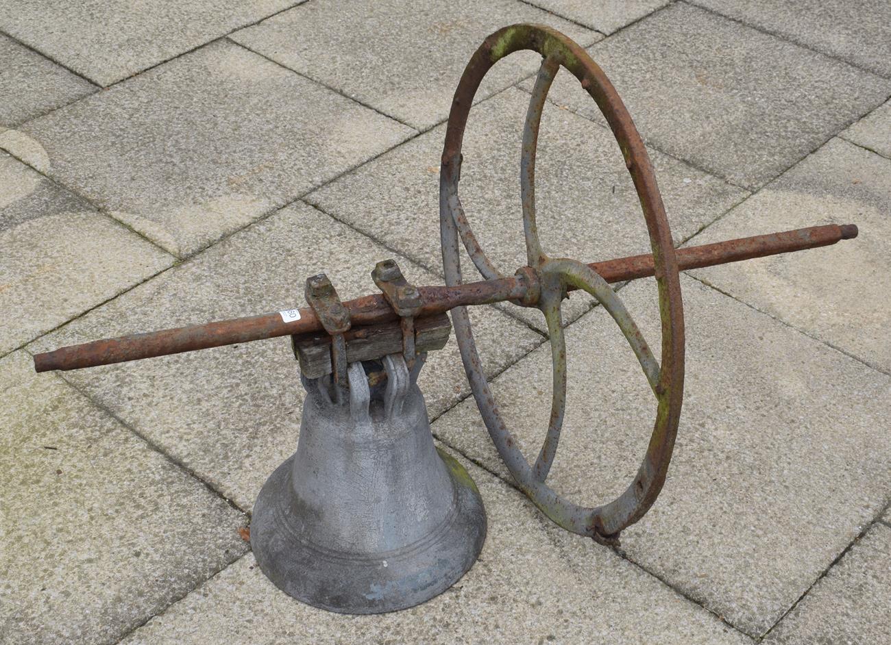 A large church bell and wheel