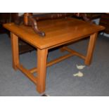 A modern golden oak farmhouse kitchen table, 136cm by 89cm by 75cm high