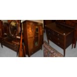 A four-piece Edwardian mahogany bedroom suite, comprising a dressing table, wardrobe, chest of