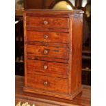 A 19th century miniature chest of five small drawers