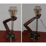 A pair of wooden arm form table lamps