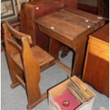 An early 20th century oak schoolroom desk, with slant front and integral seat