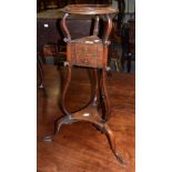 An early 19th century mahogany wig stand on tripod base
