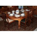 A set of four oak hall/dining chairs with green leather drop-in seats; together with a pair of