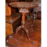 A George III style carved mahogany tripod table, the associated pie-crust top above a birdcage