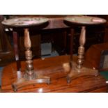 A pair of 19th century mahogany wine tables, the dish circular tops above turned standards over a