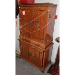 A reproduction burr walnut gilt metal mounted cocktail cabinet, with mirrored and marbled