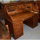An early 20th century oak roll-top desk