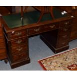 A leather inset pedestal desk